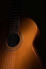 Obraz premium Classical guitar close up on a black background 