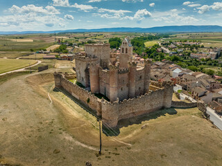 Obraz premium Aerial view of Turégano a village and municipality of Spain in the province of Segovia, Castile and León. Medieval feudal castle with donjon, circular towers integrating church of San Miguel