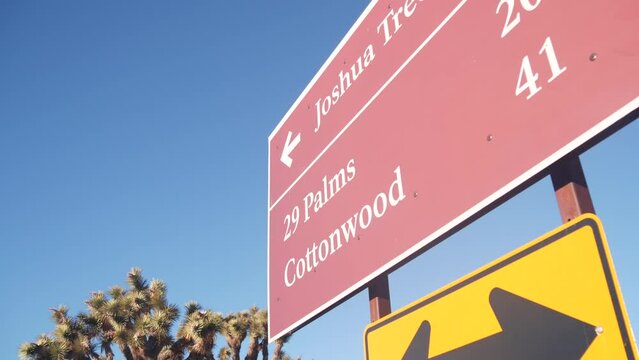 Crossroad sign with direction arrows on road intersection, California USA. Travel destination for trip on vacations. Joshua Tree national park, desert wilderness. Hitchhiking traveling in yucca valley