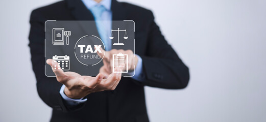 Hand using tablet with bar  TAX REFUND and refund tax of duty taxation business, graphs and chart being demonstrated on the screen media,  tablet pc and selecting tax refund.