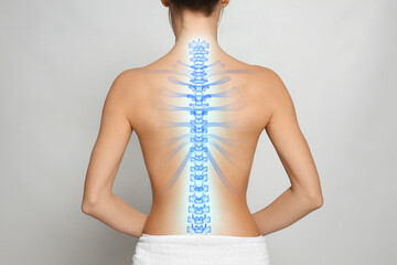 Woman with healthy spine on light background, back view