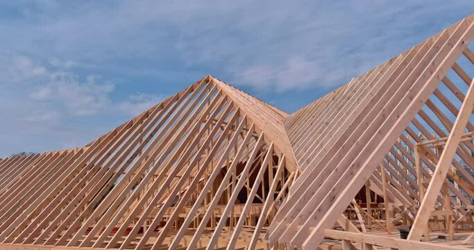 Close-up view of wooden beams, rafters, joist with nail plywood panels on the roof an aerial view