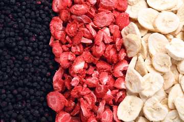 Closeup of freeze dried blueberries, strawberries and bananas as background, top view - obrazy, fototapety, plakaty
