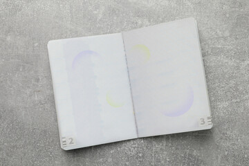 Blank passport on grey table , top view