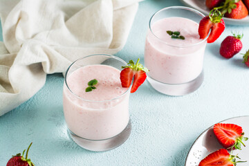 Healthy smoothie with strawberries and mint in glasses on the table. Homemade dessert