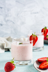 Milk smoothie with strawberries and mint in glasses. Healthy homemade food. Vertical view