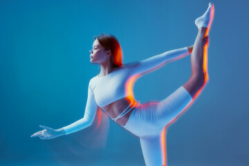 Slim flexible girl stretching body with raised leg. Ballet workout. Fitness, pilates, gymnastics training. Long exposure