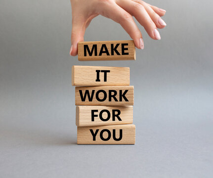 Make it work for you symbol. Business Concept words Make it work for you on wooden blocks. Beautiful grey background. Businessman hand. Business concept. Businessman hand. Copy space