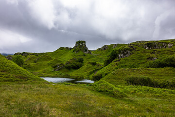 Fototapeta na wymiar The Fairy Glen is located in the hills above the village of Uig on the Isle of Skye in Scotland. A strange landscape created by a landslip.