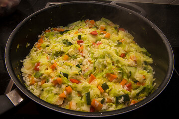 Detail of rice and vegetables cooking in a large pot. Healthy meal.