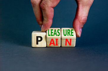 Pain or pleasure symbol. Concept words Pain or Pleasure on wooden cubes. Businessman hand. Beautiful grey table grey background. Business and pain or pleasure concept. Copy space. - obrazy, fototapety, plakaty
