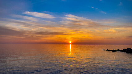 Fototapeta na wymiar Summer sea design template. Beautiful sunset on tropical beach and sunlight on horizon