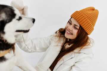 woman in the snow playing with a dog fun friendship Lifestyle