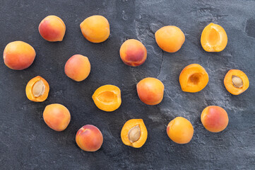 Delicious ripe sweet apricots on dark background, top view. Space for text