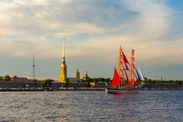 Scarlet sails ship on Neva river and Peter and Paul fortress during White nights festival, Saint Petersburg, Russia