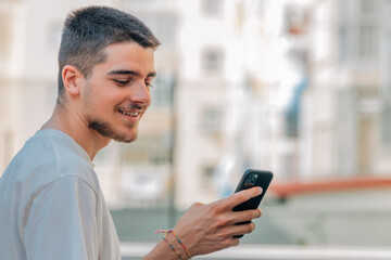 young man with mobile phone in the street