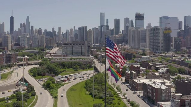 Aerial, drone footage of a Rainbow Flag over Chicago Skyline during Pride Month