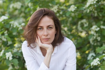 sad middle aged woman relaxed outdoors. copy space. concept without stress. mental health. Slow life. Enjoying the little things. spends time in nature in summer