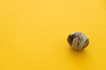 Small quail eggs on a yellow background, healthy food