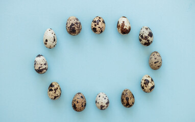 quail eggs on light blue background copy space