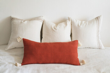 Fototapeta na wymiar Linen pillows on a white bed. Comfortable bed with pillows in room. Modern home decor. Interior design. Template.