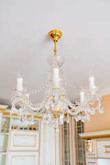 Beautiful classic crystal ceiling lamp on the ceiling of the apartment. 
