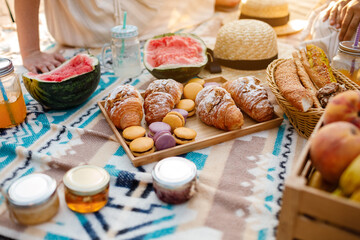 Beautiful summer picnic on the beach. Organic fresh fruit, croissants, colourful macarons or...