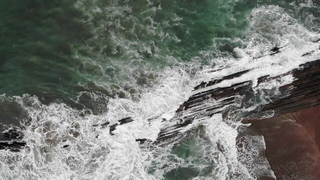 Aerial drone view of famous flysch of Zumaia, Basque Country, Spain. Flysch is a sequence of sedimentary rock layers that progress from deep-water