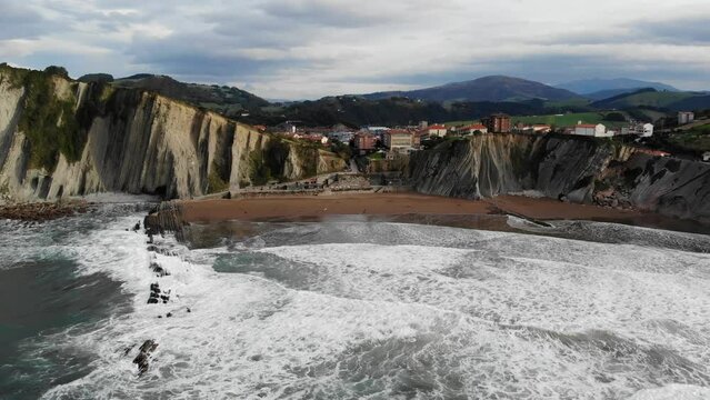 Aerial drone view of famous flysch of Zumaia, Basque Country, Spain. Flysch is a sequence of sedimentary rock layers that progress from deep-water