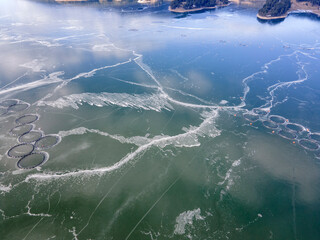 Aerial winter view of Dospat Reservoir covered with ice, Bulgaria