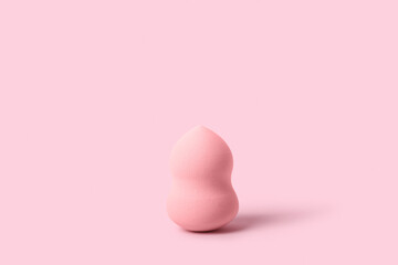 Fototapeta premium Makeup sponge on pink background