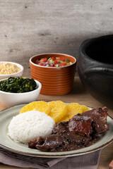 Typical Brazilian feijoada on the table.