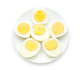 Plate with cut boiled eggs on white background