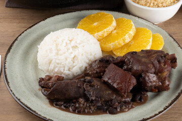 Focus on delicious Brazilian feijoada on plate.