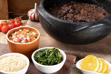 Brazilian delicious food feijoada on the table.