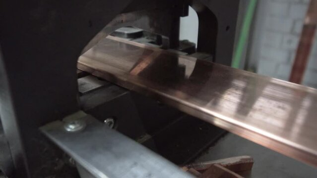 Automatic hydraulic cnc machine cuts metal copper in a factory, factory.