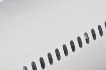 Detalhe de um avião de grande porte no grafismo de janelas
