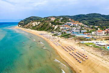 Aerial drone view of Agios Stefanos beach, a small tourist resort on the north east coast of Corfu in Greece - obrazy, fototapety, plakaty