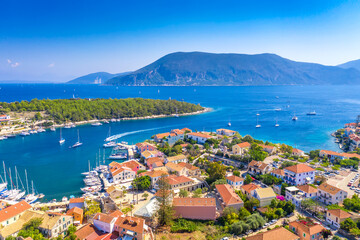 Fototapeta premium Aerial drone view of Fiscardo village port with luxury boats and yachts on Kefalonia island, Greece.