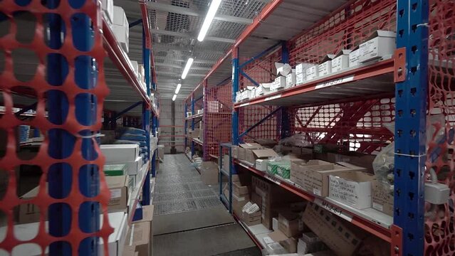 large factory warehouse. store aisles. The camera pans between shelves inside a large store. Delivery to the warehouse. Logistics business and forklift truck to move boxes and goods. freight mail