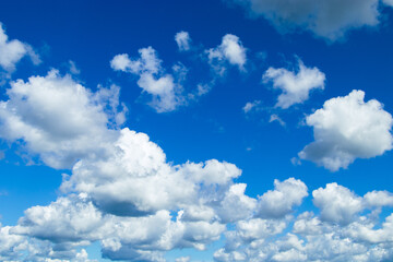 Beautiful summer blue sky. Fluffy white cumulus clouds.