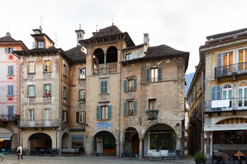 Fototapeta na wymiar View of medieval buildings in central historical square Piazza del Mercato of Domodossola city on winter day, Italy.