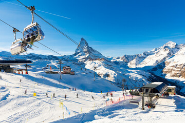 Picturesque alpine landscape with view of chairlift station of modern ski resort at foot of high...