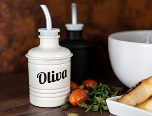 olive oil and vinegar with a salad bowl.