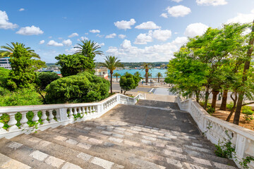 View of the Georgian architecture, Mediterranean Sea and port harbor from the grand staircase leading to the historic old town of Mahon or Mao on the Island of Menorca, Spain.	
