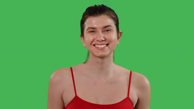 portrait young happy woman looking camera toothy smiling dressed red top Isolated on Green Screen studio