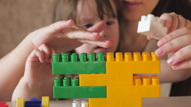 children blocks game. kid dreams building. child care. cognitive colorful development baby girl. classes with designer in kindergarten. playful child imagining tower building strategy. work group team.