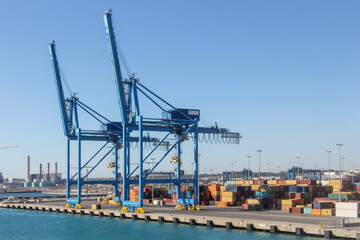 Fototapeta na wymiar Cranes at a container port, Civitavecchia, Italy