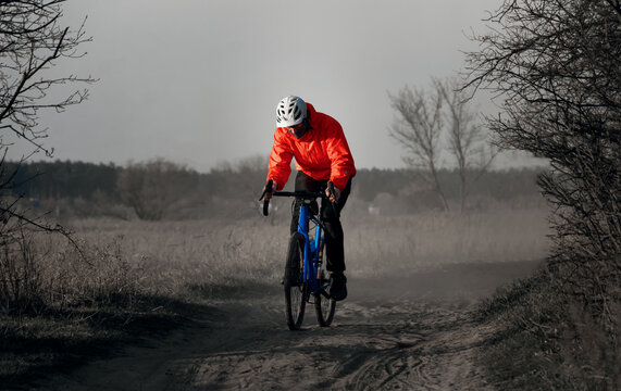 Cyclist rides gravel bicycle along on a trail. Extreme sports and activity concept.