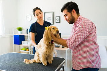 Depressed man putting down his dog at the animal clinic